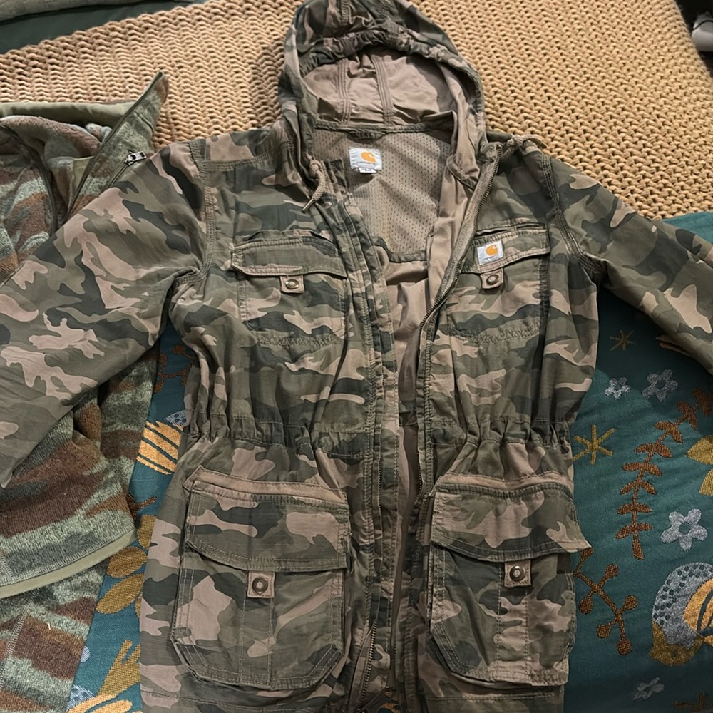 hooded light weight jacket with adjustable waste, button wrists.  Size Medium